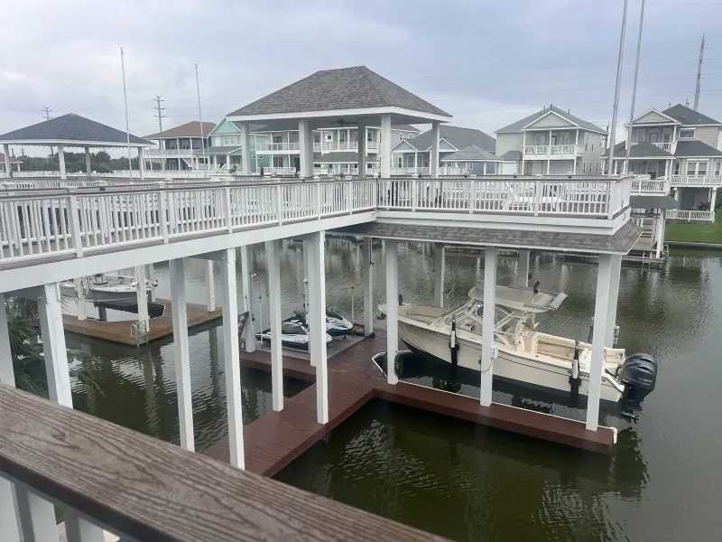 Washed boat dock and elevated walkway on a Galveston canal