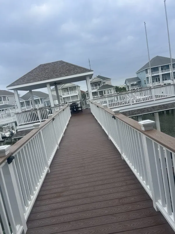 Clean composite walkway leading to a dock gazebo