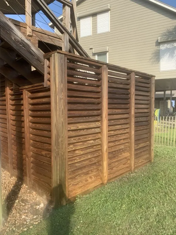 After: clean warm-brown louvered fence