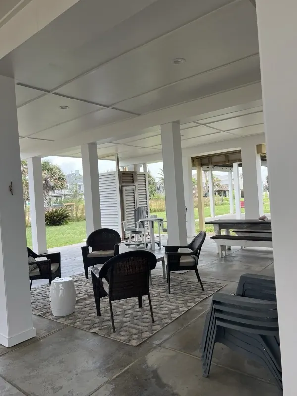 After: clean under-house patio set up with seating