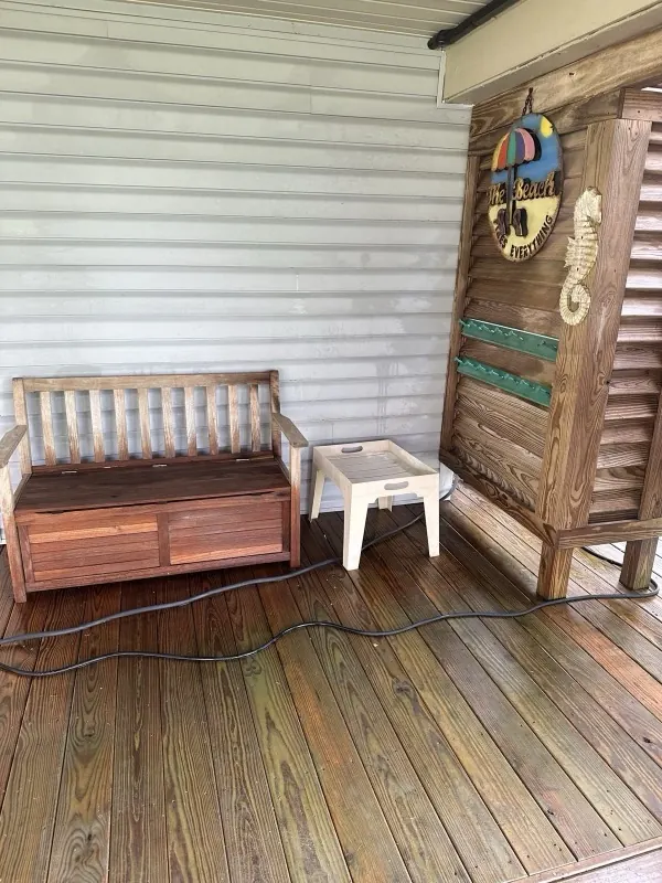 After: clean siding and deck with the same bench